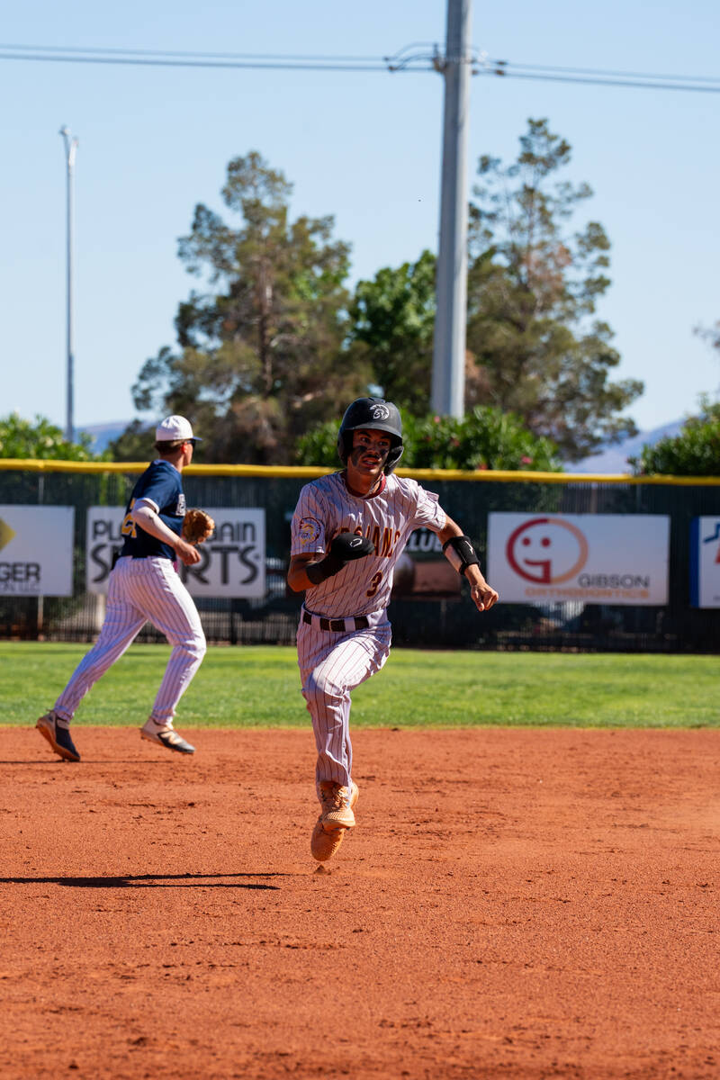 Pahrump Valley High senior Vinny Whitney charges toward third base during the Trojans' 7-1 road ...
