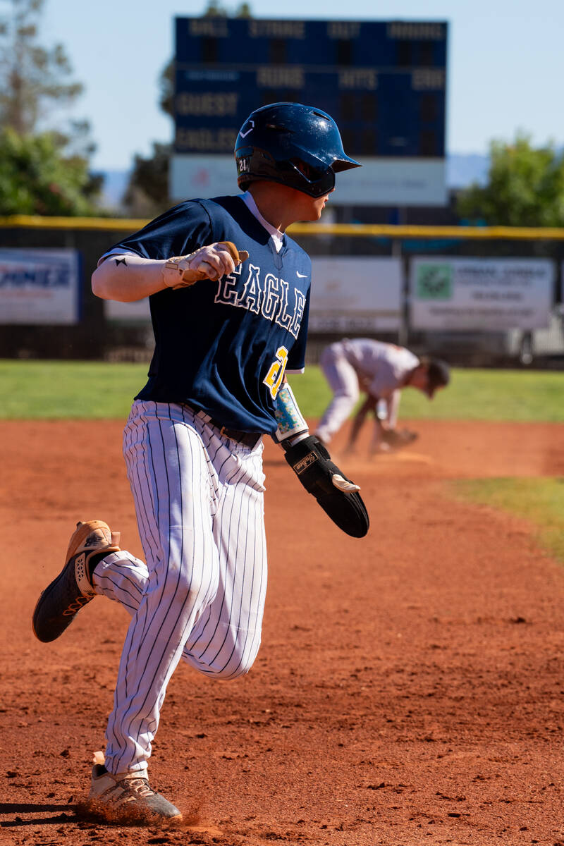 Boulder City High School junior Cael Starley attempts to round third base to head home during t ...