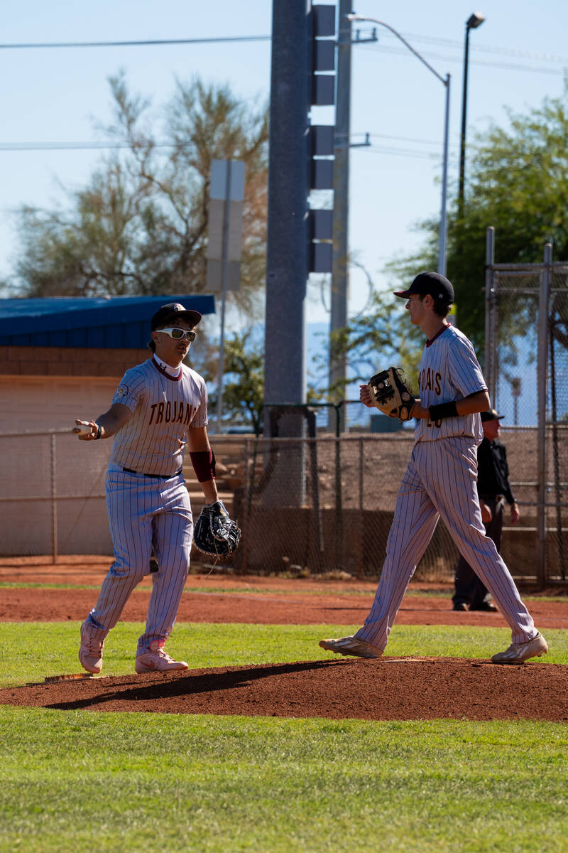 Pahrump Valley High School starting pitcher Samuel Mendoza and sophomore INF CJ Nelson gather o ...