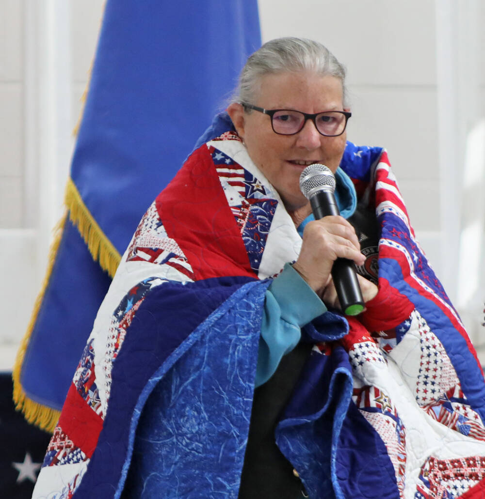 Air Force veteran Sherry Connors speaks before a crowd of fellow veterans and citizen, offering ...