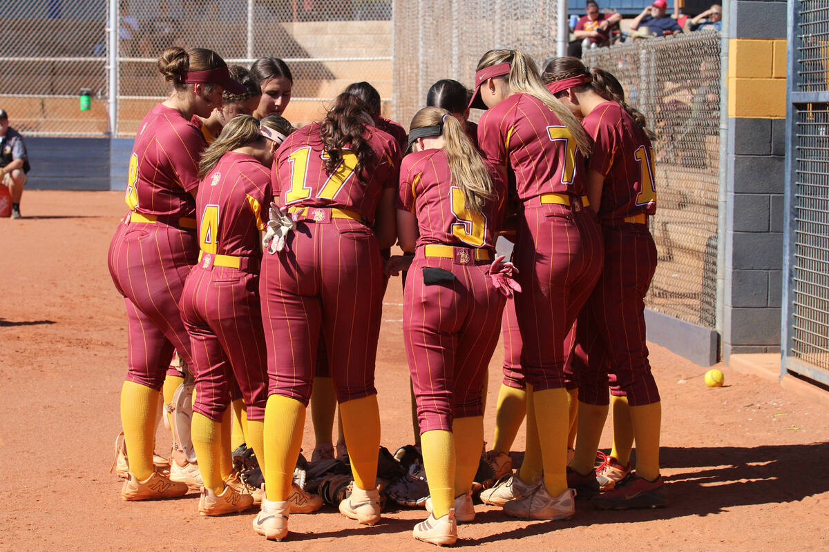 The PVHS varsity softball team gathers together for a team message prior to the start of their ...