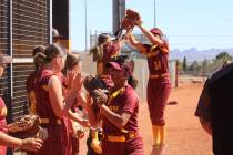 Members of the Pahrump Valley High School varsity softball team celebrate together during their ...