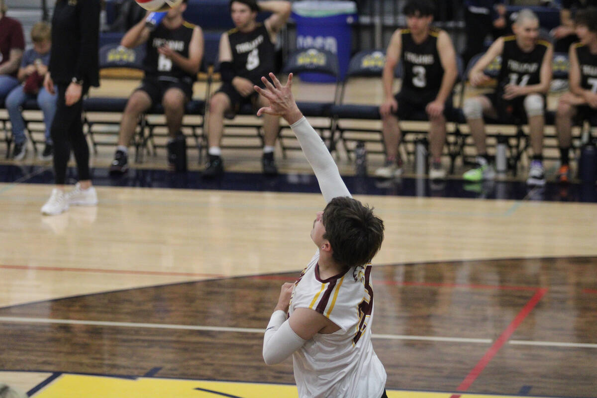 Pahrump Valley High School senior libero Jack Schable sends a ball from the service line over t ...