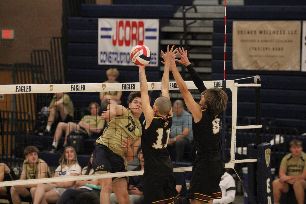 Pahrump Valley High School boys volleyball players George Anderson and Elijah Thompson attempt ...