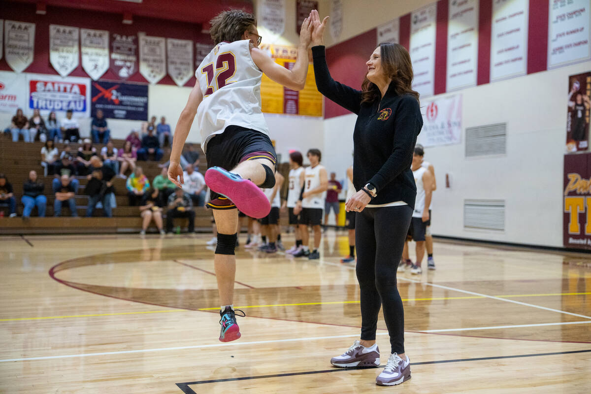 Pahrump Valley High School senior James Wilson connects with Coach Lugo for an enthusiastic hig ...