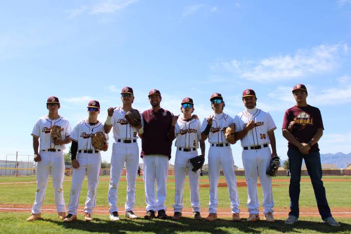Pahrump Valley High School's graduating seniors pose with Trojans head coach Drew Middleton nea ...