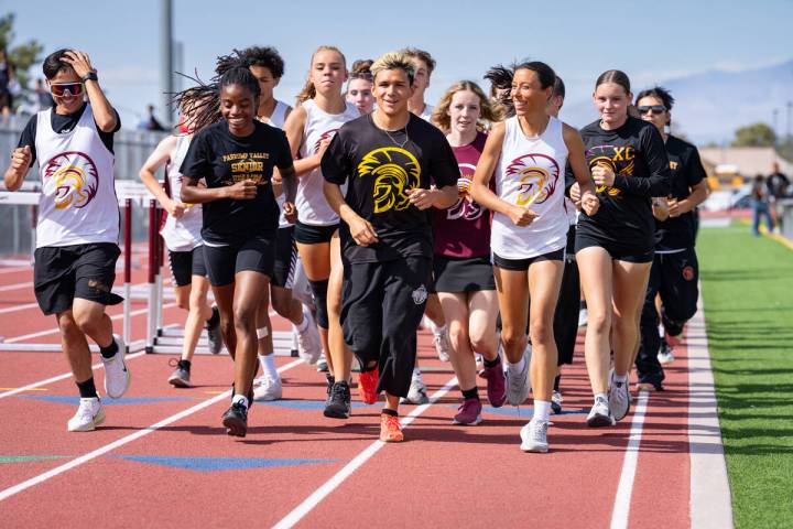 Pahrump Valley High School's Track & Field program takes a warm-up lap prior to the seniors' la ...