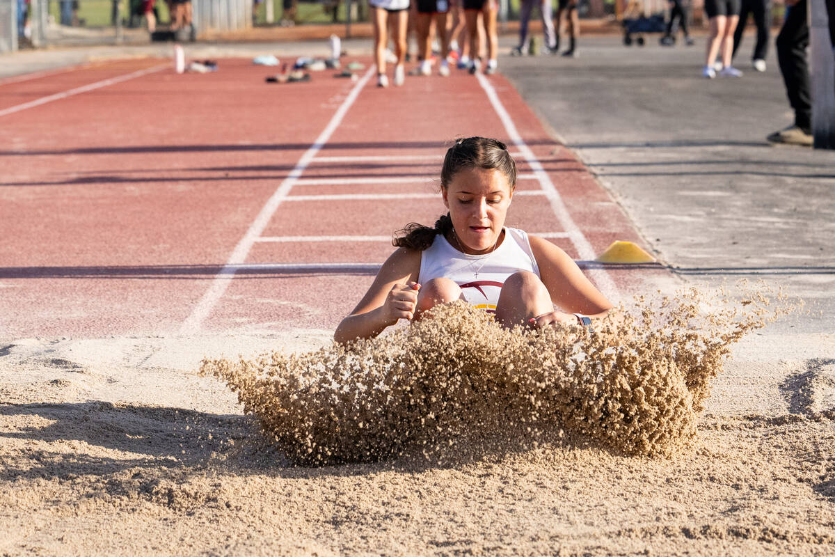 Pahrump Valley High School sophomore Melanie Carson lands in the pit after her long-jump attemp ...