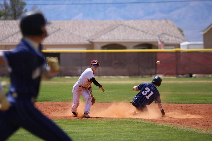 Pahrump Valley High School senior Leland Delgado completes a double play a second base against ...
