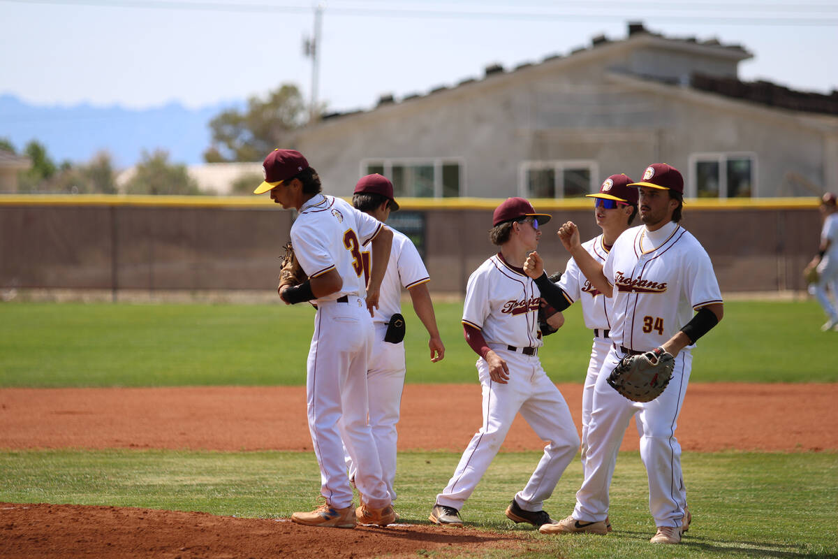The Trojans show some love on the mound to starting pitcher and senior Vinny Whitney during Sen ...