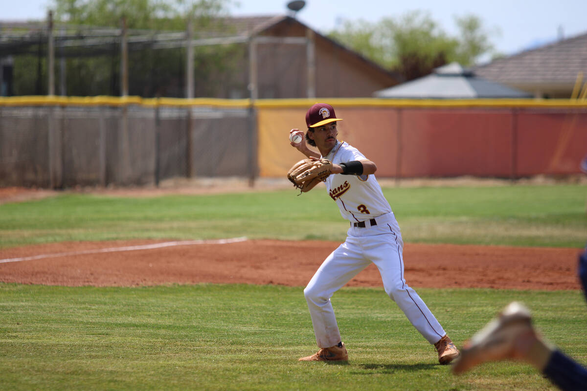 Pahrump Valley High School senior Vinny Whitney cleanly fields a ball dribbled back to the moun ...