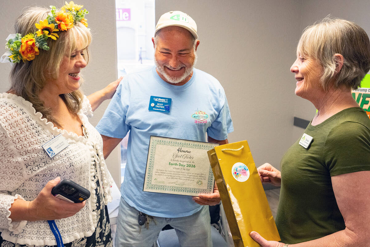 Scot Troter, center, was honored as the Earth Day 2026 Citizen of the Year during the Earth/Arb ...