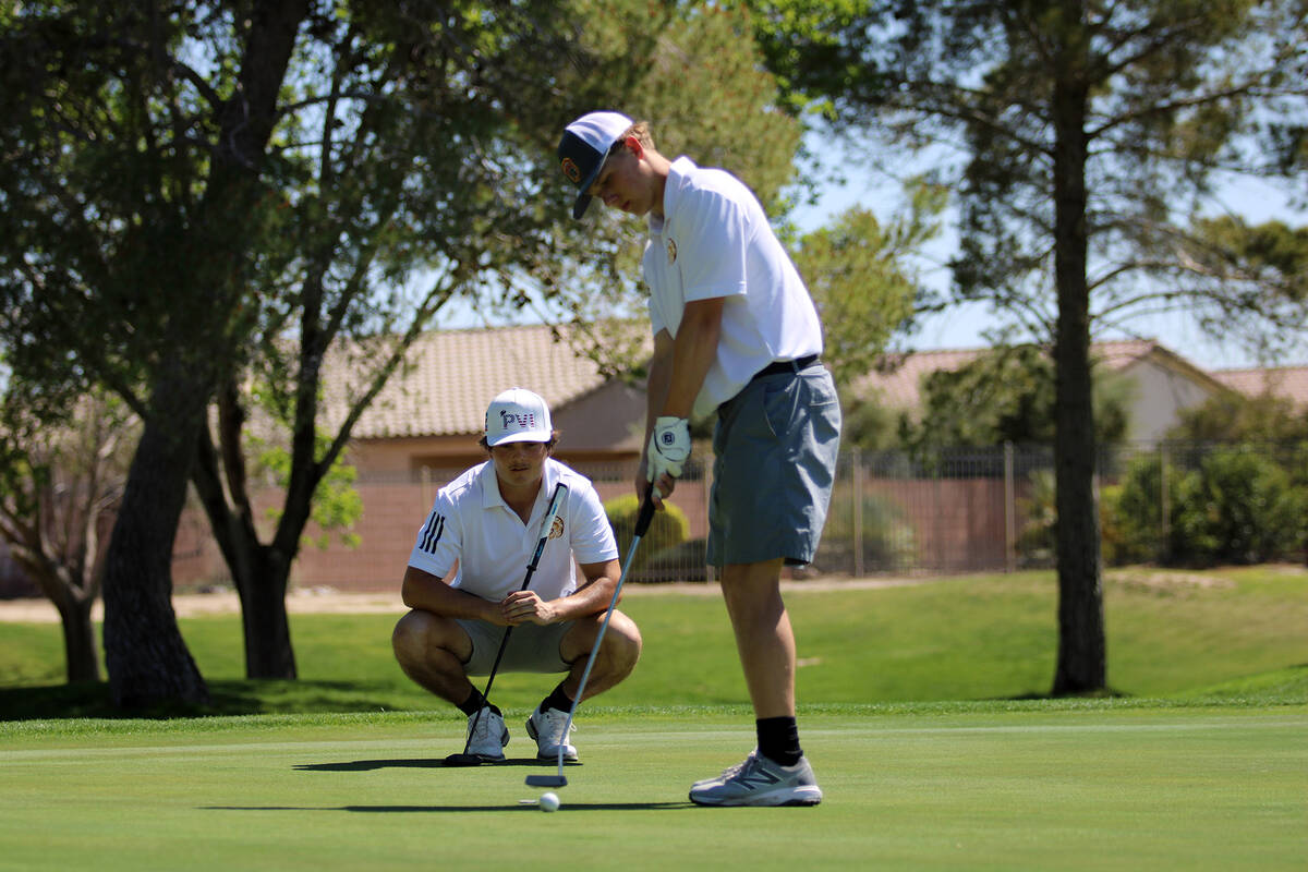 Pahrump Valley High School boys golf junior TC Hone attempts to sink a putt to finish his round ...
