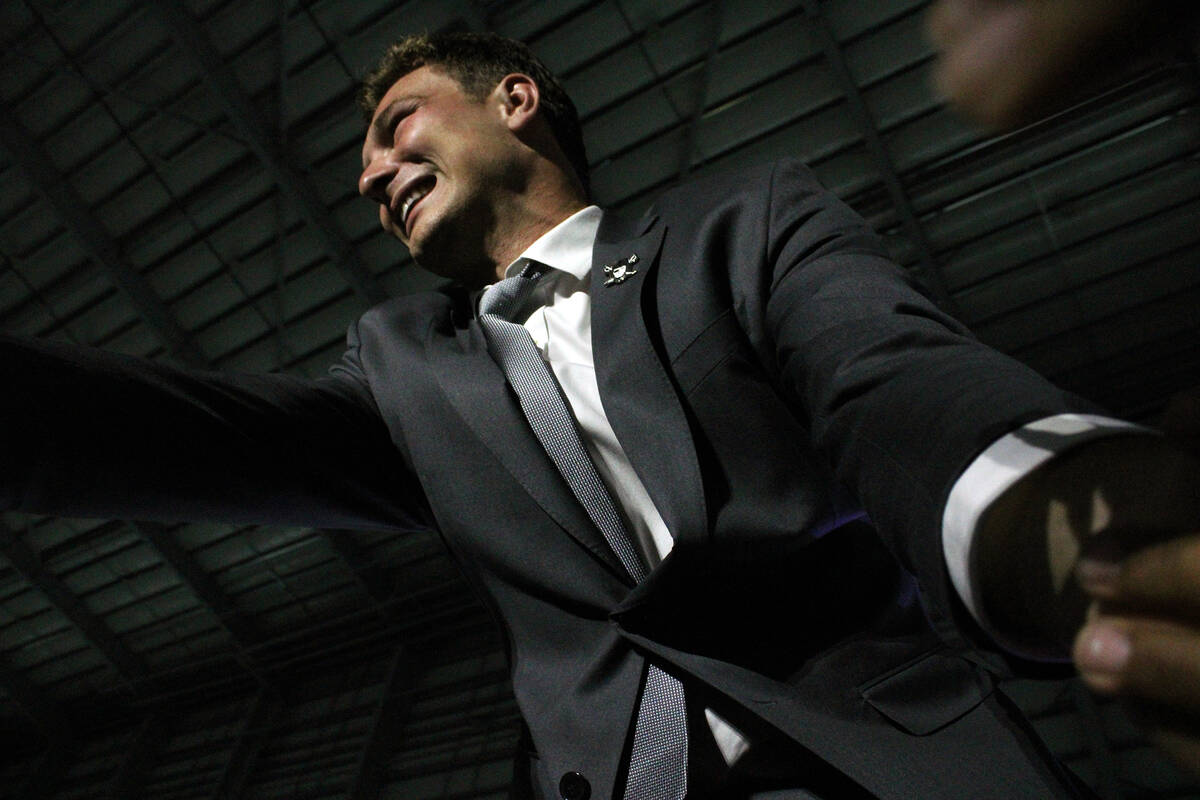 Fernando Mendoza shakes hands with Raiders fans before answering a few questions on stage durin ...