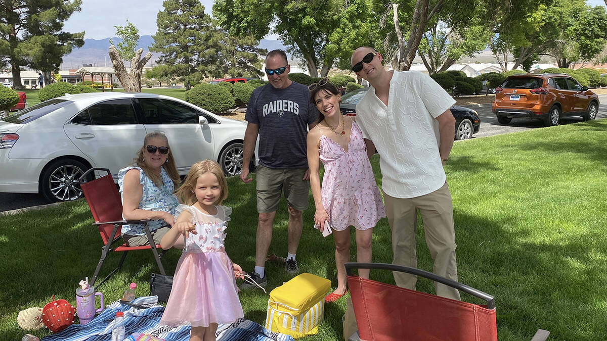 A family at the Celebration of Life - Live Butterfly Release poses for a photo while a recently ...