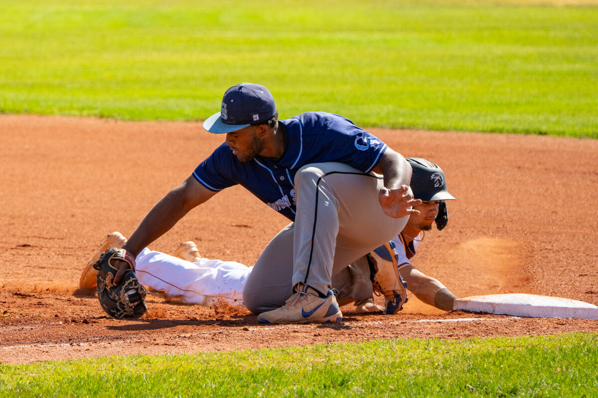 Pahrump Valley High School junior shortstop Tony Whitney evades a tag at first base during the ...