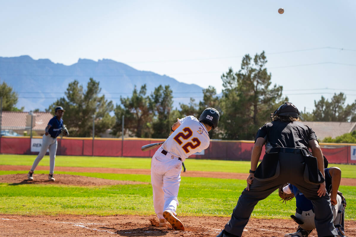 Pahrump Valley High School junior Tony Whitney launches a ball into right field during the Troj ...