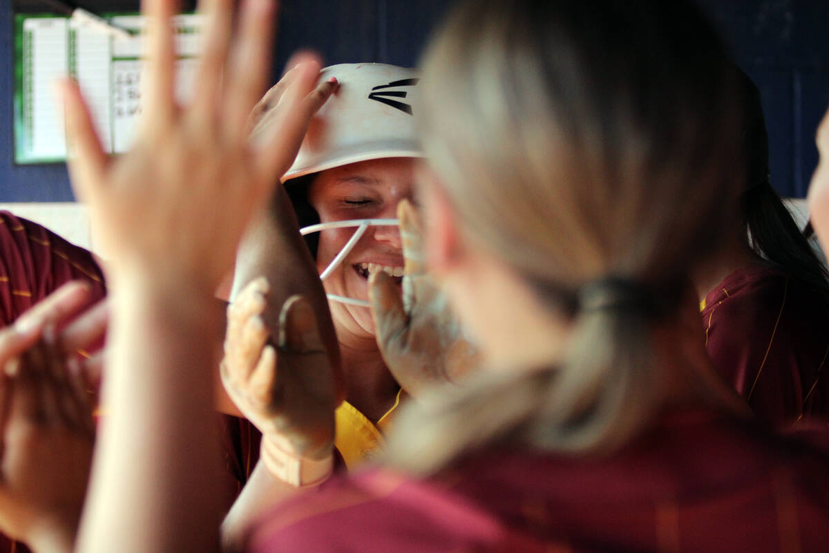 Pahrump Valley High School sophomore and catcher Mariah Gray is celebrated after coming around ...