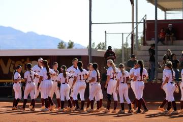 The Lady Trojans exchange high-fives after defeating The Meadows 15-0 in their last regular sea ...