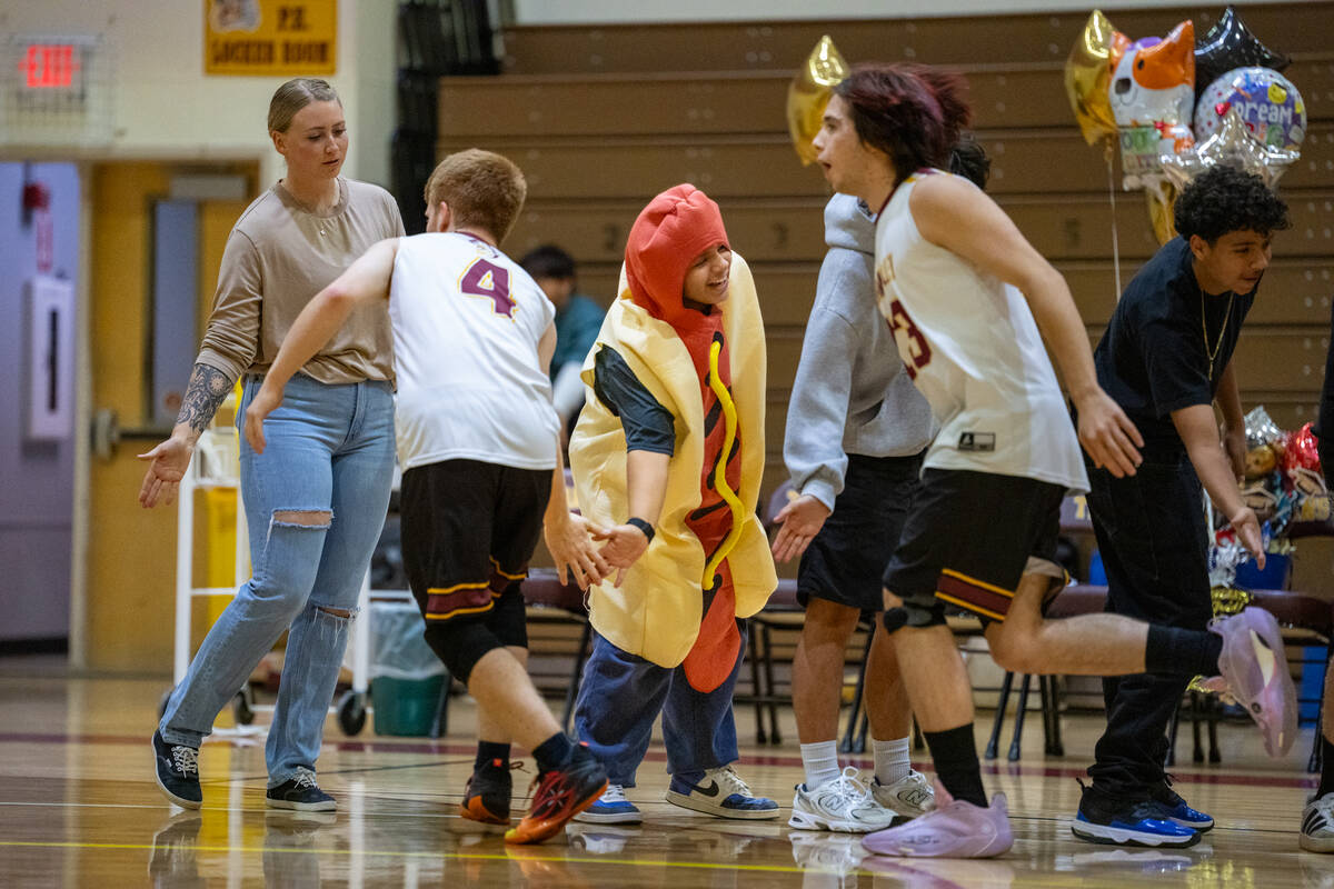 Pahrump Valley High School boy's volleyball teammates William Coen and Emery Miller-Rocha dash ...