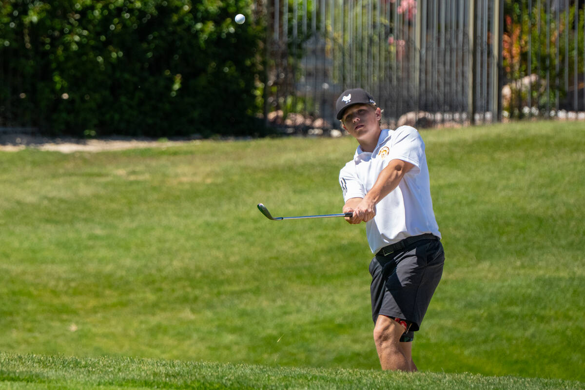 Pahrump Valley High School boys golf junior TC Hone chips a shot during day one of the Class 3A ...