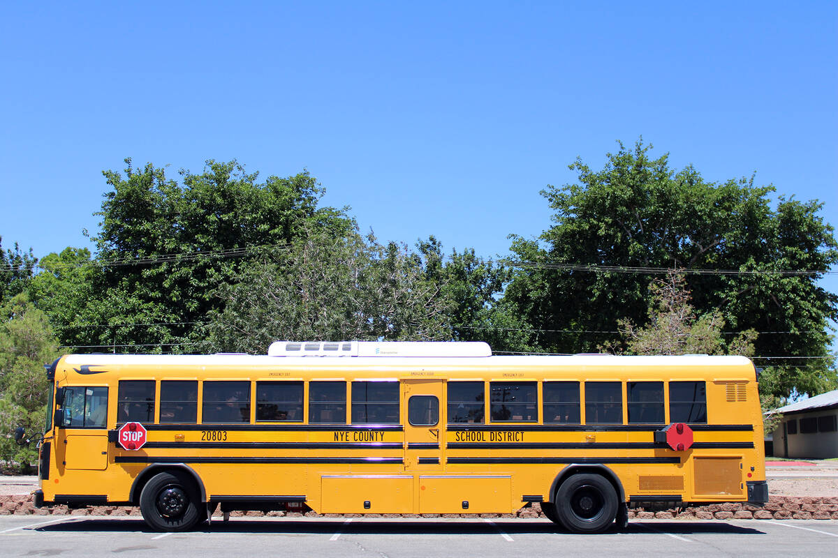 The Lady Trojans' team bus is parked in front of the stadium in Boulder City as the girls fight ...