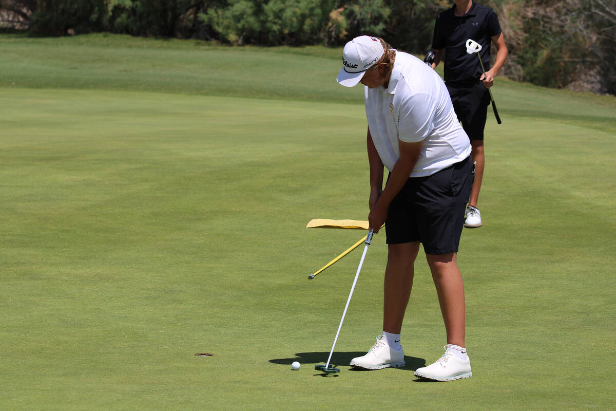 Pahrump Valley High School boys golf freshman Brody Myers attempts to wrap up his putt cleanly ...