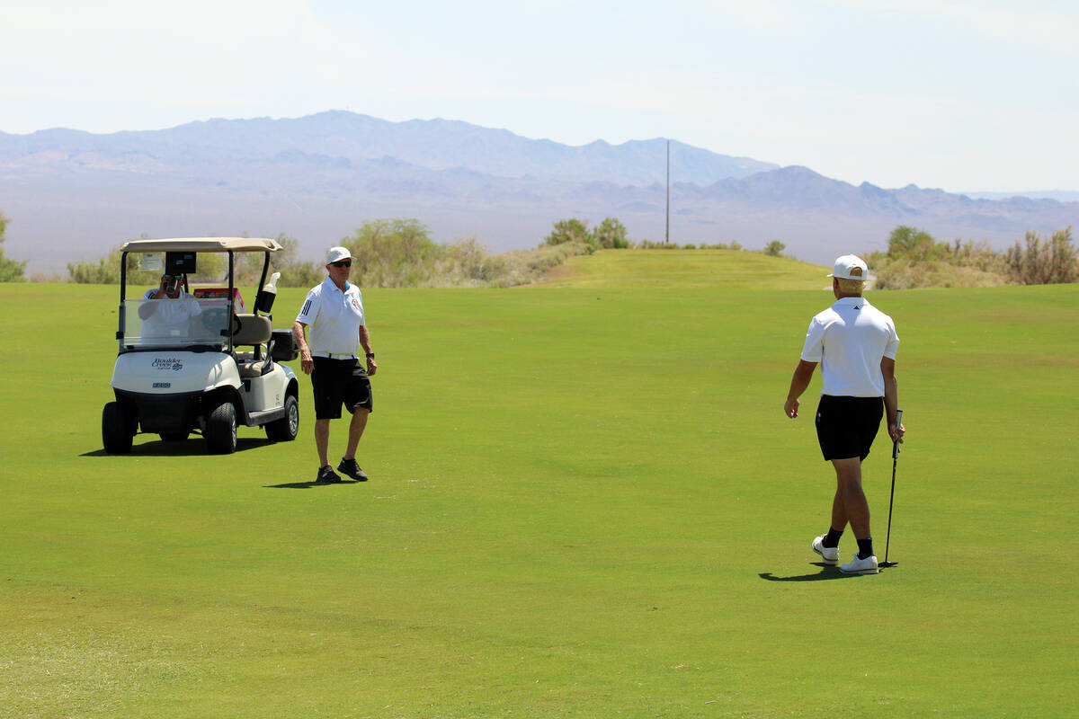 Pahrump Valley High School junior Aaron Rily and Trojans head coach Bob Hopkins meet to strateg ...
