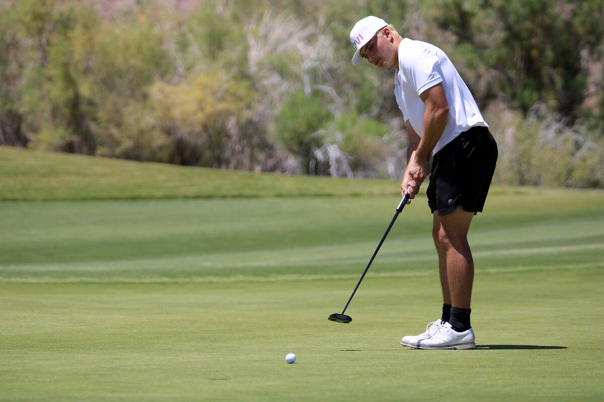Pahrump Valley High School junior Aaron Rily attempts to sink a birdie during the Class 3A Stat ...