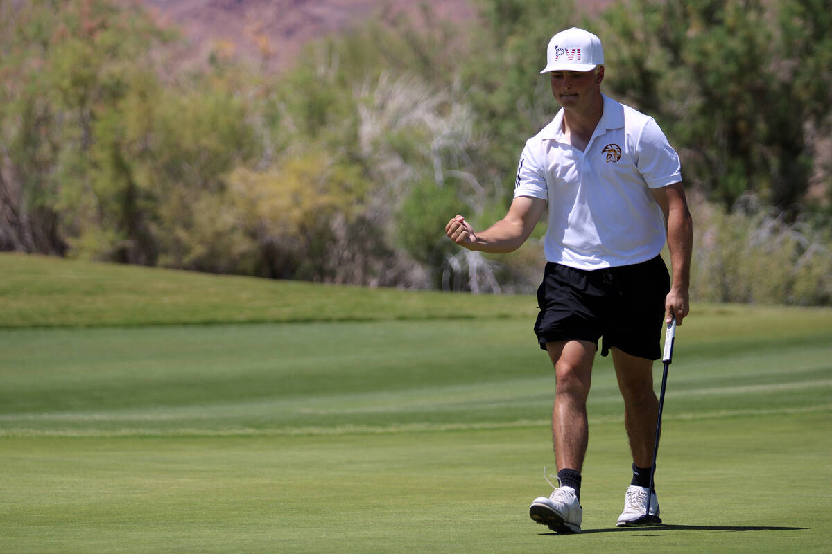 Pahrump Valley High School junior Aaron Rily celebrates after sinking a birdie during the Class ...