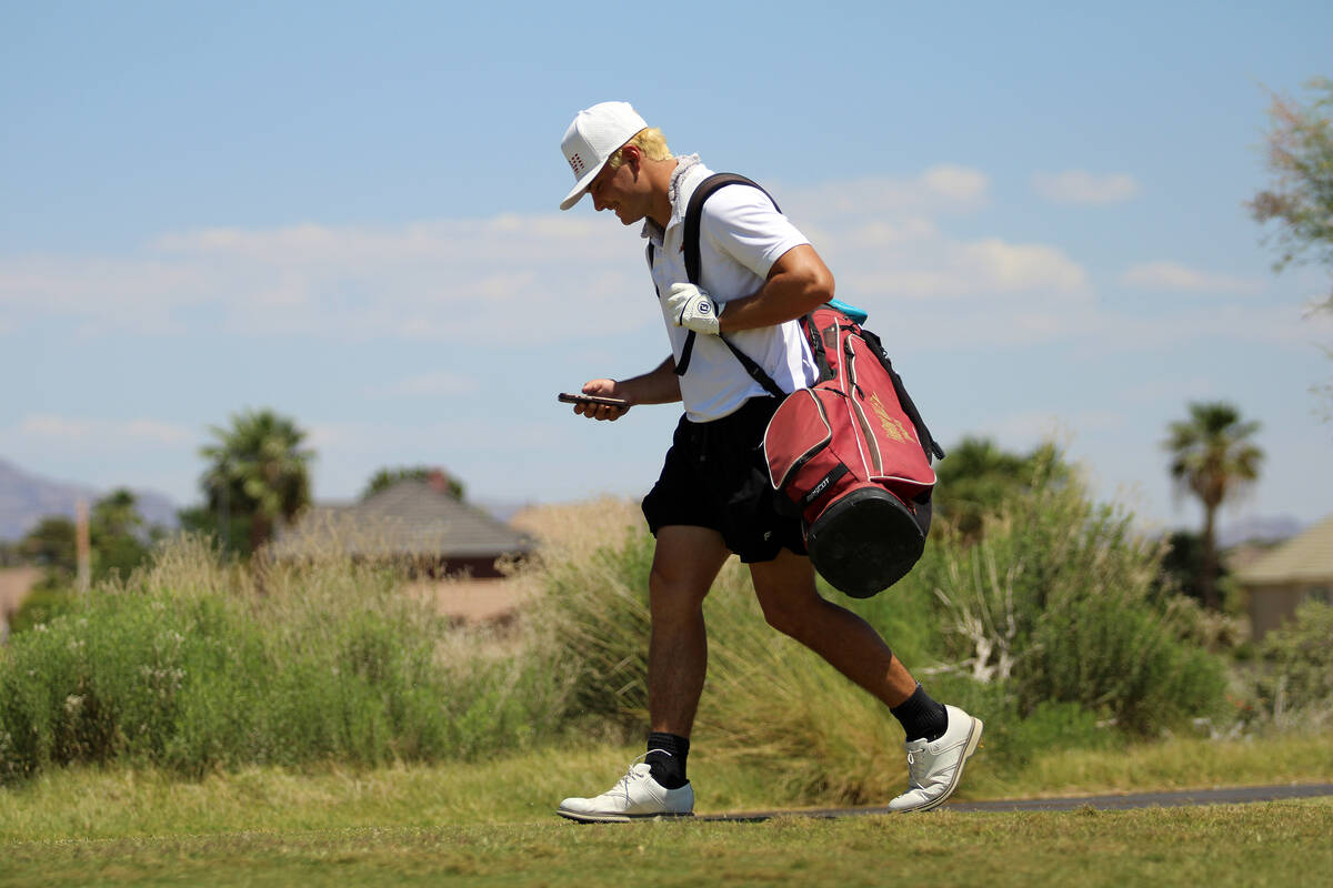 Pahrump Valley High School junior Aaron Rily checks the tournament's live scores during the Cla ...