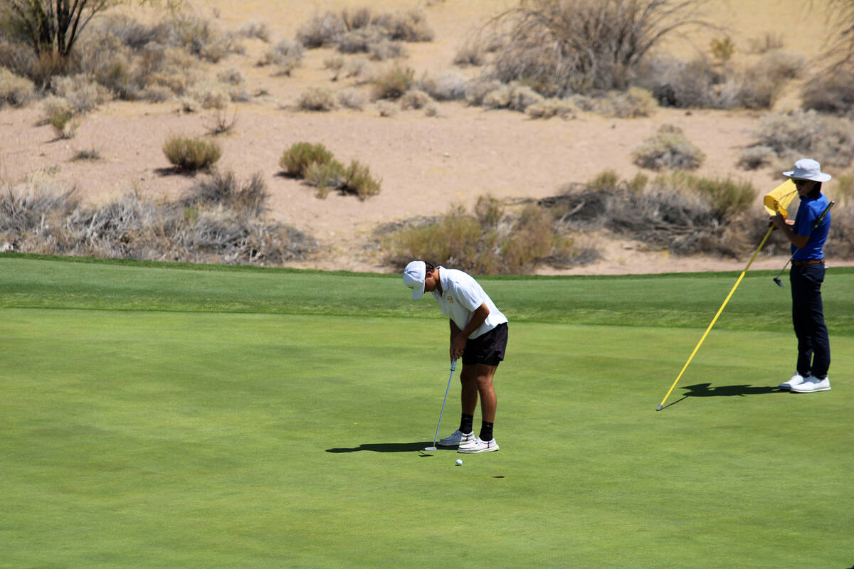 Pahrump Valley High School junior Travis Floyd puts his focus into sinking a putt to close out ...
