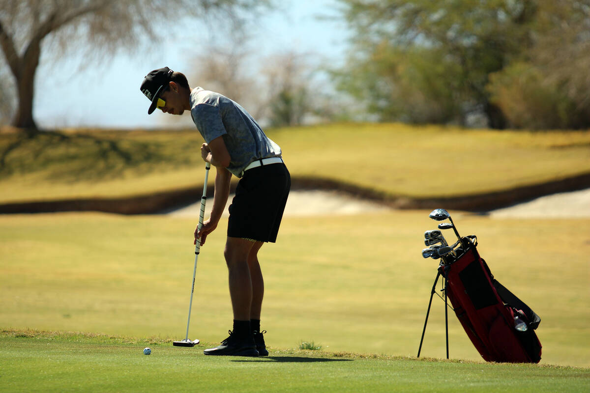 Pahrump Valley High School senior Cayden Cowley focuses on sinking a putt during a league match ...