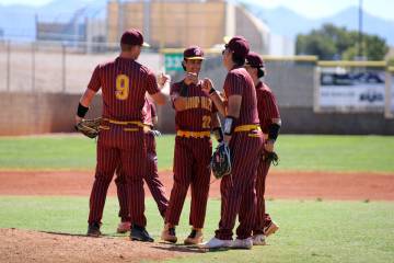 The Trojans infield gathers for a quick fist bump prior to the start of their playoff game agai ...