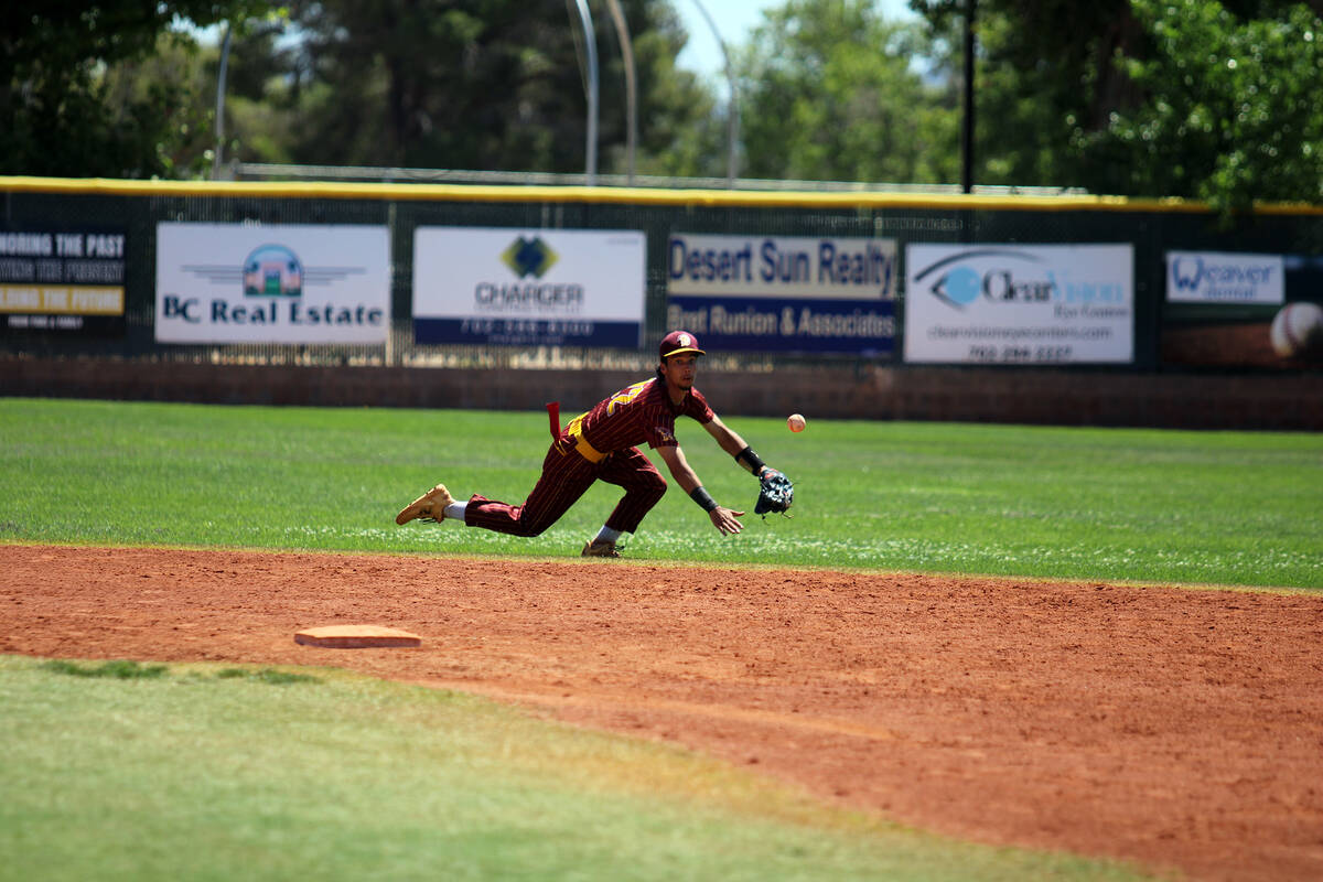 Pahrump Valley High School junior shortstop Tony Whitney extends out to try and herd a ball up ...