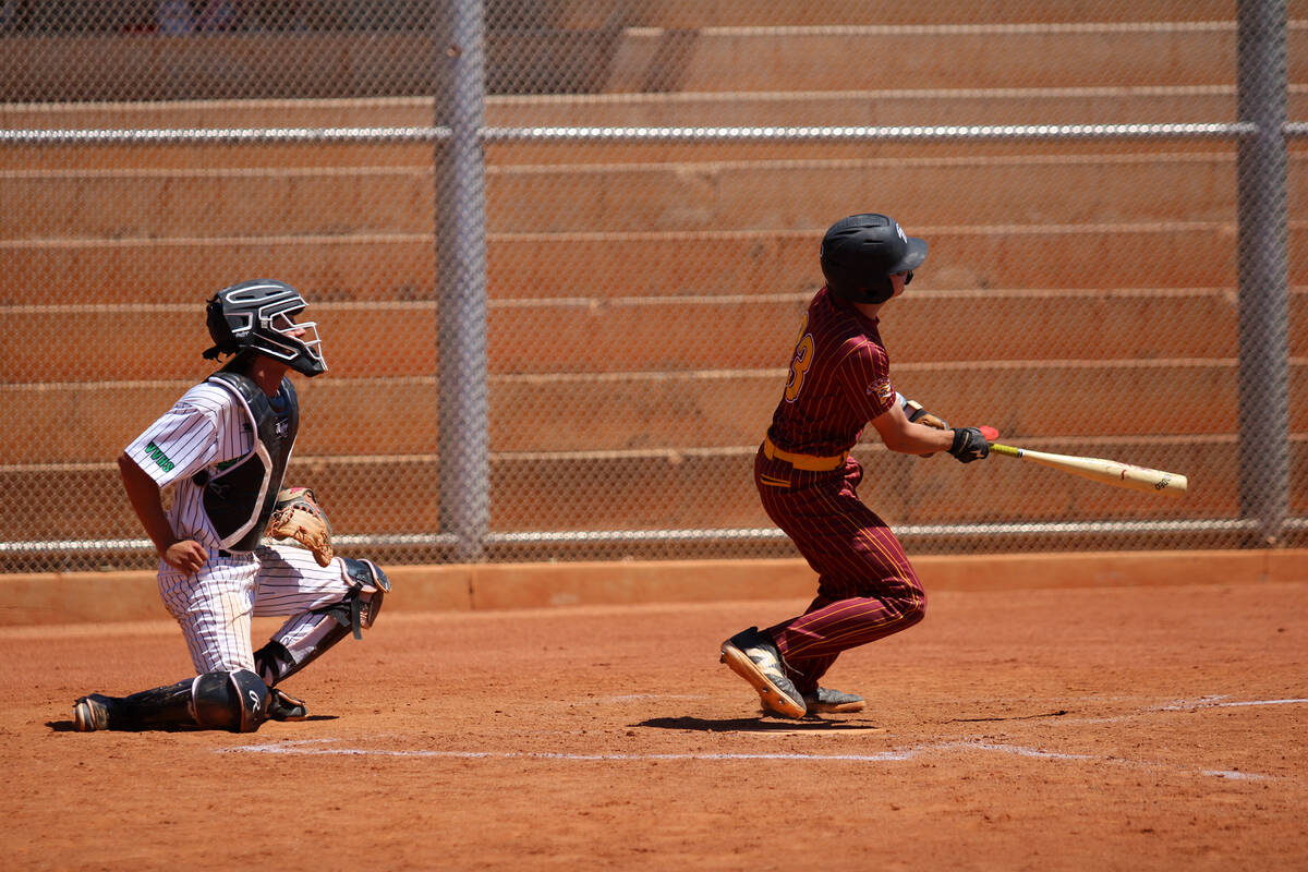 Pahrump Valley High School junior catcher Ben Cimperman pieces a ball up during the Class 3A So ...