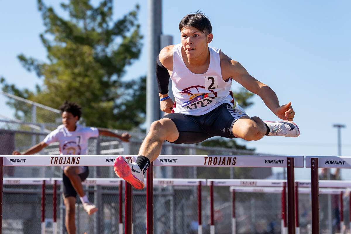 Pahrump Valley High School senior Ulisses Alvarez clears a hurdle during the Class 3A Southern ...