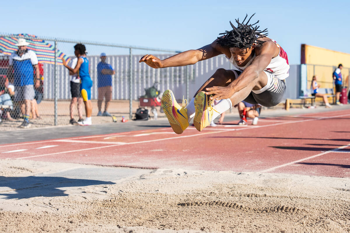 Pahrump Valley High School senior Jayden Crisler participates in the long jump during the Class ...