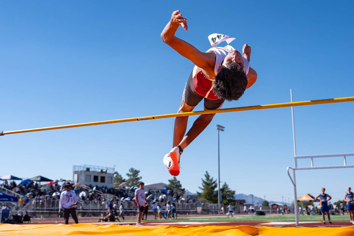 Pahrump Valley High School freshman Kristoffer Trejo launches himself over the bar in the high ...