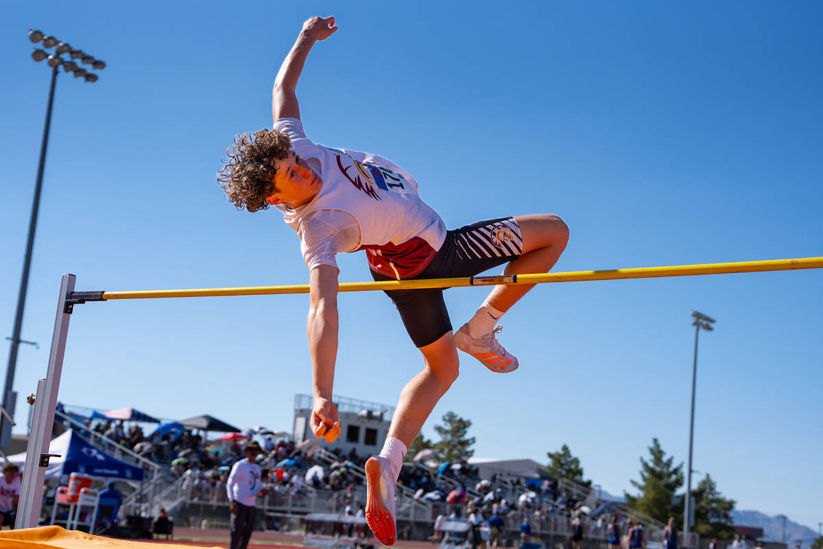Pahrump Valley High School freshman Evan Strain launches himself over the bar in the high jump, ...