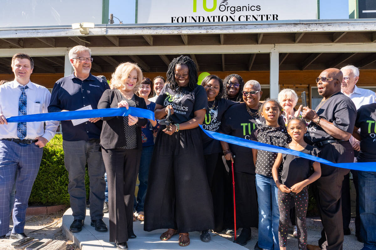 Mariatu “Tu” Browne (center), surrounded by members of the Chamber of Commerce, friends, fa ...