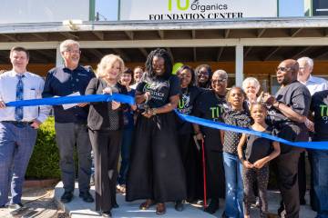 Mariatu “Tu” Browne (center), surrounded by members of the Chamber of Commerce, friends, fa ...