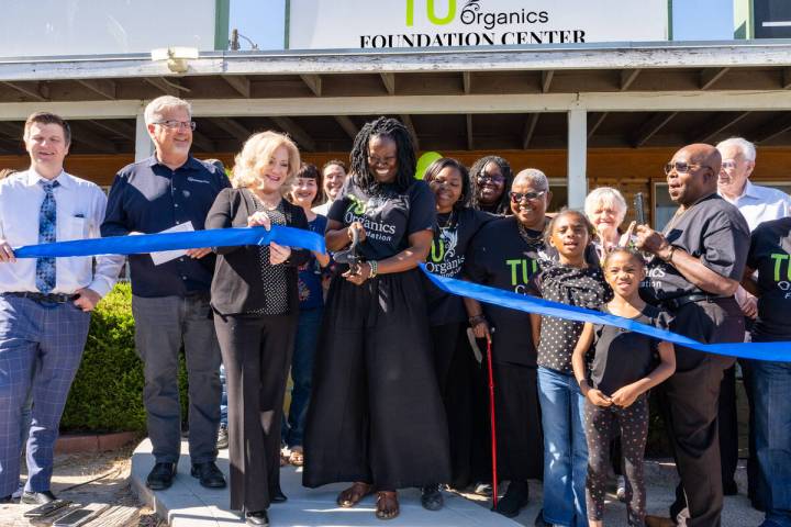 Mariatu “Tu” Browne (center), surrounded by members of the Chamber of Commerce, friends, fa ...