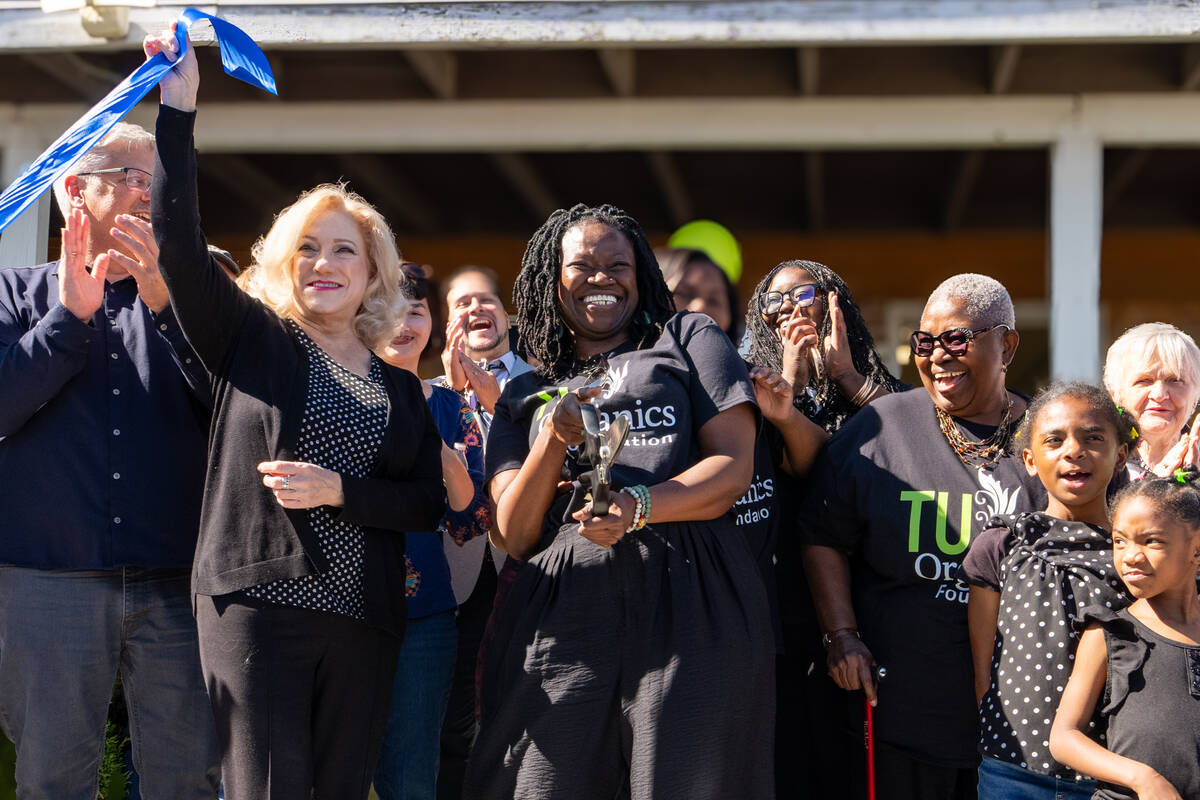 Mariatu “Tu” Browne (center), surrounded by members of the Chamber of Commerce, friends, fa ...