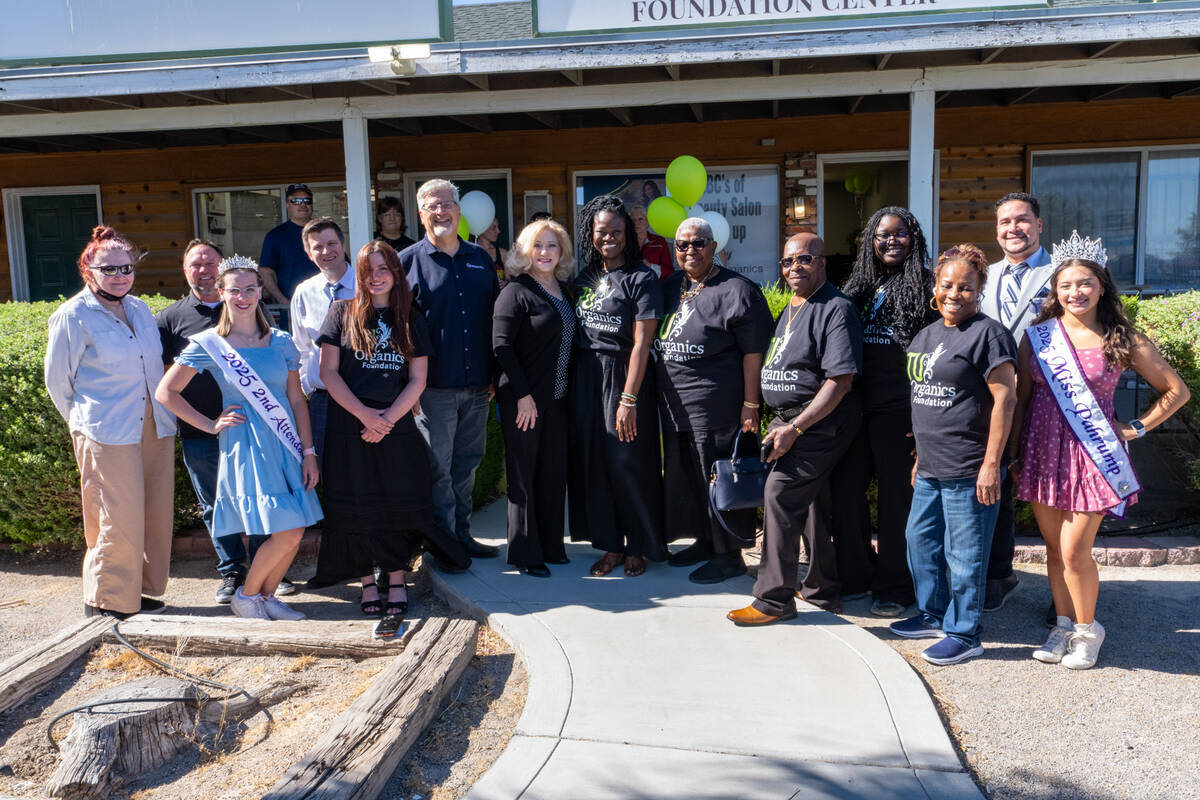 Mariatu “Tu” Browne (center), surrounded by members of the Chamber of Commerce, friends, fa ...