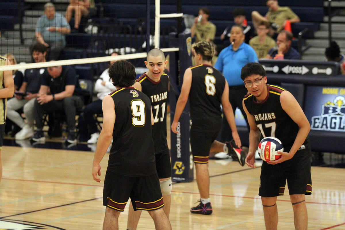 The Trojans take a quick break in-between sets against Boulder City High School during a league ...