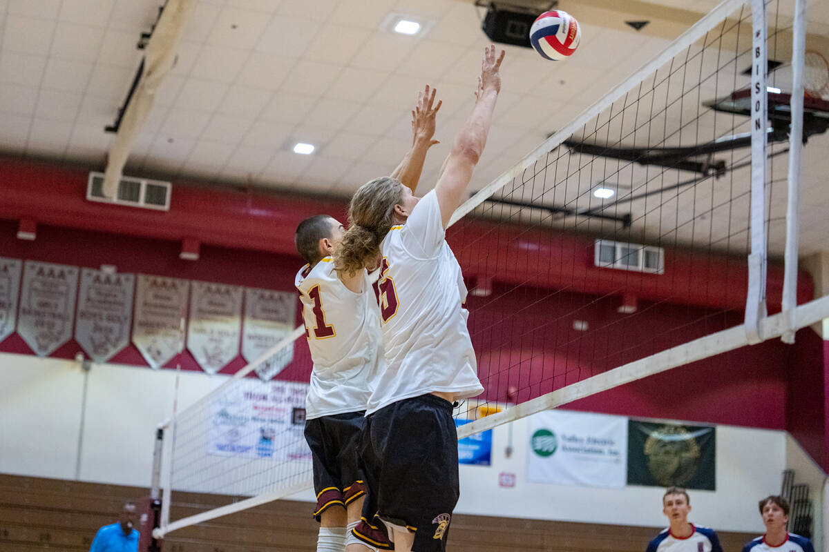 Pahrump Valley High School boys varsity volleyball teammates junior George Anderson (left) and ...