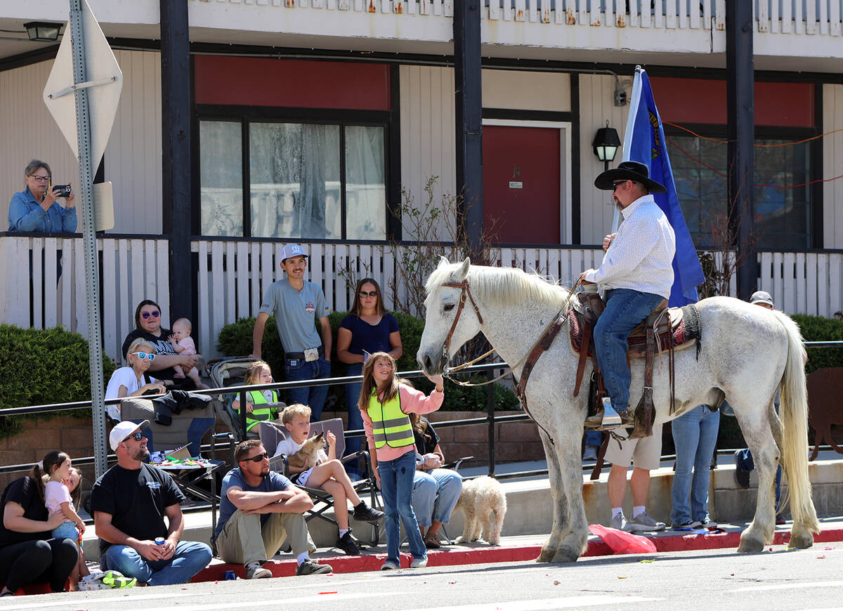 Equines are always a big draw for parade attendees and one young girl was eager to pat a white ...