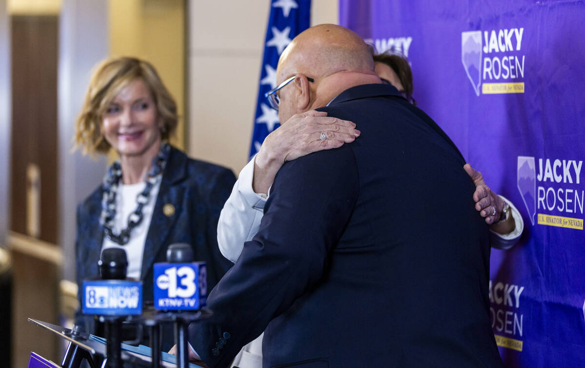 Sen. Jacky Rosen hugs Dave Crete with Congresswoman Susie Lee after speaking during a press con ...