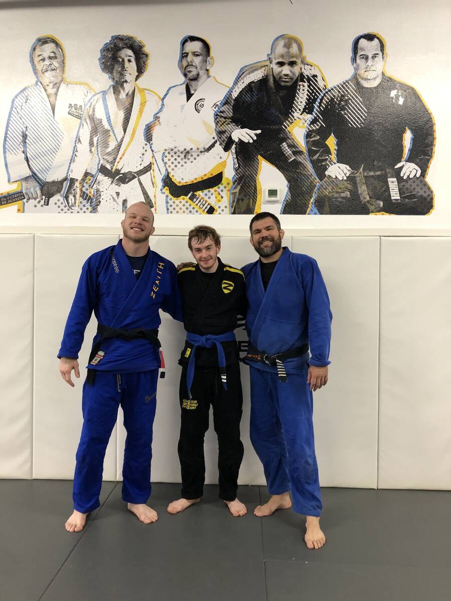 Zackery Wilson poses with trainers Nick Hartman and Robert Drysdale at Zenith Jiu Jitsu headqua ...